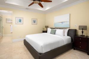 a bedroom with a large bed and a ceiling fan at Abundance and Prosperity Villa in Long Bay Hills +29 photos