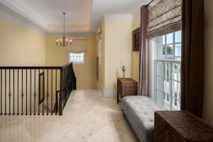 a living room with a staircase and a large window at Abundance and Prosperity Villa in Long Bay Hills