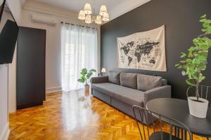 a living room with a couch and a table at Home Out Rooms & Apartments in Lisbon