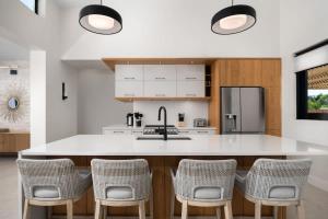 a kitchen with a white counter and chairs at Upper East Side Enclave # 18 in Leeward