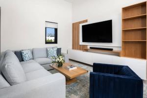 a living room with a couch and a tv at Upper East Side Enclave # 18 in Leeward
