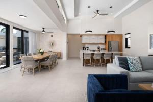 a living room with a couch and a table and a kitchen at Upper East Side Enclave # 18 in Leeward