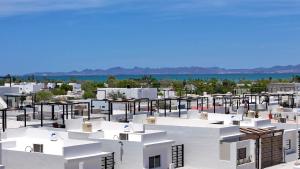 arial view of a white building with the ocean in the background at 3BR House with Pool & Rooftop Terrace in El Centenario +53 photos