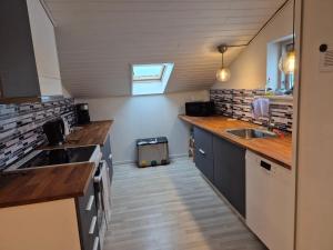a small kitchen with a sink and a counter at Værelser til leje 5 in Hørve