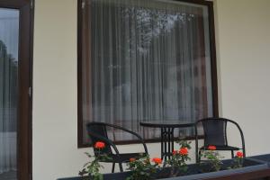 a balcony with two chairs and a table and a window at Amaras Boutique Hotel Lori in Stepʼanavan