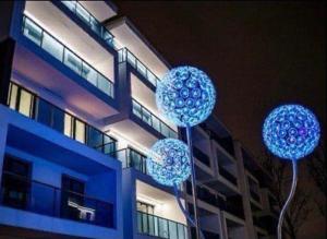 three blue spheres on poles in front of a building at The Nest in Otopeni +6 photos