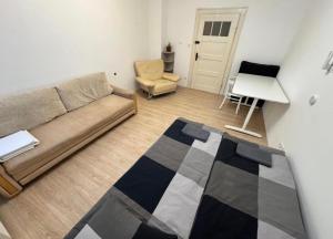 a living room with a couch and a chair at Pokoje Zbąszynek in Zbąszynek