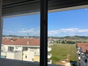 a view of a city from a window at Ajans Apartament in Golem +4 photos