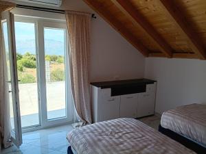 a bedroom with a bed and a large window at Vila Nikola in Pučišća +20 photos