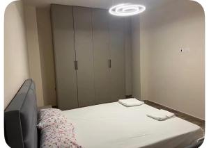 a bedroom with a bed and a tv in it at Ajans Apartament in Golem