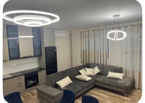 a living room with a couch and a table at Ajans Apartament in Golem