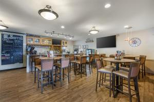 a restaurant with tables and chairs and a bar at Best Western Swiss Clock Inn in Pecos
