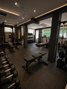 a gym with several treadmills and machines in a room at hotel Torretta Bramante in Rimini