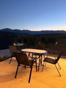 a table and chairs sitting on top of a patio at Max view Chalet Žabljak in Žabljak