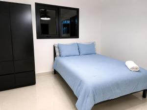 a bedroom with a bed and a black cabinet at Brand New Luxe 2BR Apt Near SJU & Airport in Carolina