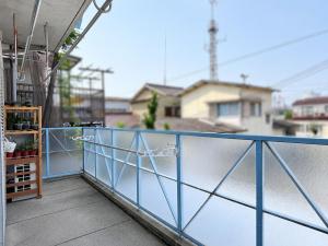 a balcony with a blue railing on a building at 晴の松 in Wakayama +12 photos