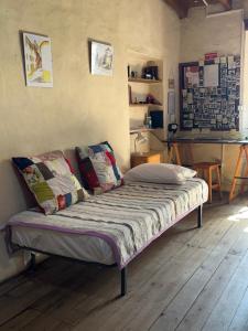 a bedroom with a bed with pillows on it at Casa Medieval de Nisa in Nisa