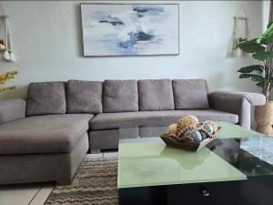a living room with a couch and a glass table at Ritz Condo in San Juan