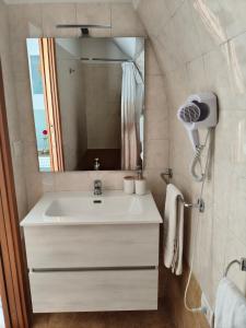 a bathroom with a white sink and a mirror at Cuore di casa Apartment in Terlizzi +22 photos