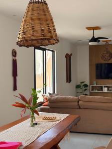 a living room with a couch and a table at Casa Macao Tibau do Sul in Tibau do Sul