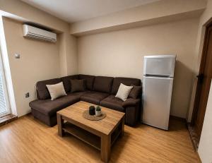 a living room with a couch and a refrigerator at Hotel Maria in Vratsa