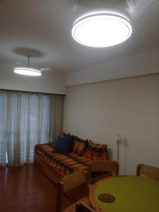 a living room with a couch and a table at Arco Iris in Miramar