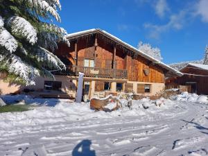 a house with a group of animals in the snow at Chambre 2 balcon in Mont-Saxonnex