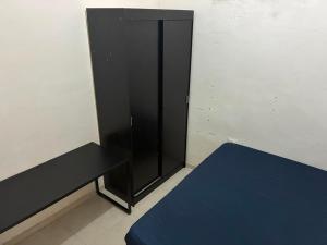 a room with a bed and a black cabinet at Apartamento, 88 in Cabo de Santo Agostinho