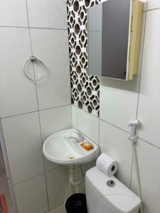 a bathroom with a sink and a toilet and a mirror at Apartamento, 88 in Cabo de Santo Agostinho +15 photos