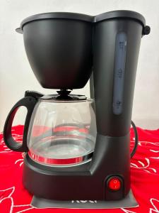 a black blender sitting on top of a red table at Apartamento, 88 in Cabo de Santo Agostinho