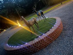 a statue of two deer standing on a grass field at Rogarnet caravan park in Three Legged Cross +6 photos