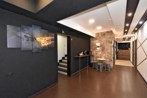 a hallway with black walls and a table and stairs at Dur baca guest house in Yerevan +29 photos
