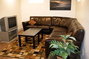 a living room with a brown leather couch and a table at JACKSON HOLE HIDEAWAY in Jackson