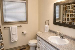 a bathroom with a sink and a toilet and a mirror at JACKSON HOLE HIDEAWAY in Jackson