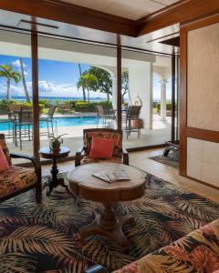 a living room with a couch and a table at Compass Blue Lahaina in Lahaina