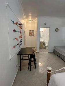 a small room with a table and a bedroom at Los Patos Waterfront Private Suites in Los Patos