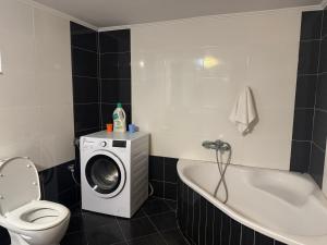 a bathroom with a washing machine and a toilet at Ksamil Harmony Studios in Ksamil +64 photos