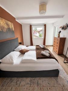 a bedroom with a large bed with towels on it at Harmony Hideaways I 90qm I Bergblick I 3 Balkone I seenah in Prien am Chiemsee