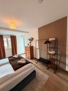 a bedroom with a large bed and a chair at Harmony Hideaways I 90qm I Bergblick I 3 Balkone I seenah in Prien am Chiemsee