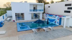 an overhead view of a house with a swimming pool at Santorini Resort in Mérida