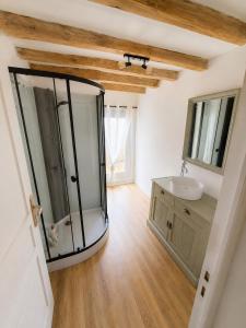 a bathroom with a glass shower and a sink at Le Clos de Tuffeau in Turquant