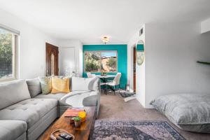 a living room with a couch and a table at Sunny & Bright Charm with Community Pool in Tucson