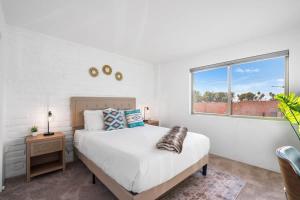 a bedroom with a bed and a window at Sunny & Bright Charm with Community Pool in Tucson
