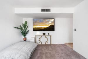 a bedroom with a bed and a painting on the wall at Sunny & Bright Charm with Community Pool in Tucson +41 photos
