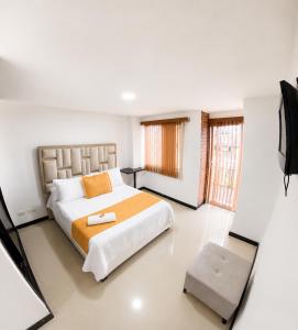 a bedroom with a large bed and a television at Hotel Cristal Plaza in Popayan