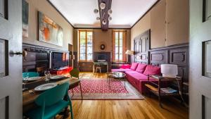a living room with a pink couch and a table at Authentic Flat in Dijon in Dijon