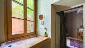 a room with a window and a bottle on a bench at Authentic Flat in Dijon in Dijon +26 photos