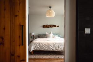 a bedroom with a bed and a pendant light at The Waterwheel in Bremerton