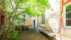 a patio with a bench next to a building at Authentic Flat in Dijon in Dijon