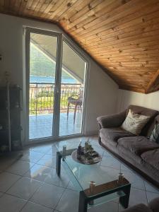 a living room with a couch and a table at Đenovici Apartmans in Đenovići